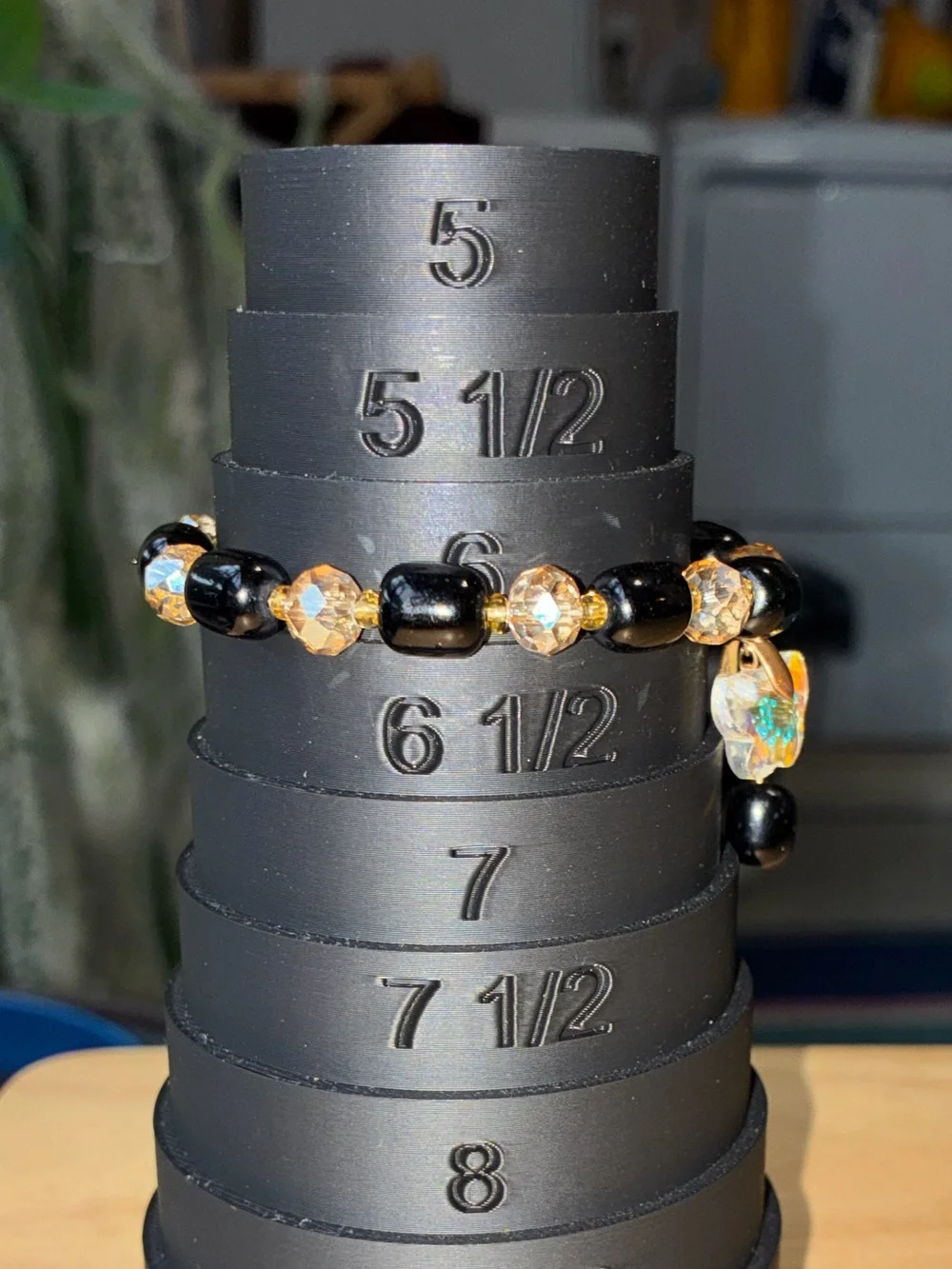 Black and Gold Beaded Stretch Bracelet with Iridescent Flower Charm - Picture 7 of 9